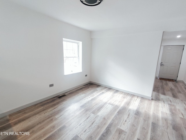 empty room with light hardwood / wood-style floors