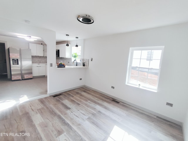 unfurnished room with sink and light hardwood / wood-style floors