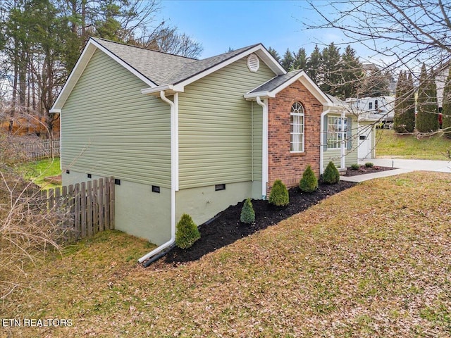 view of side of home featuring a lawn