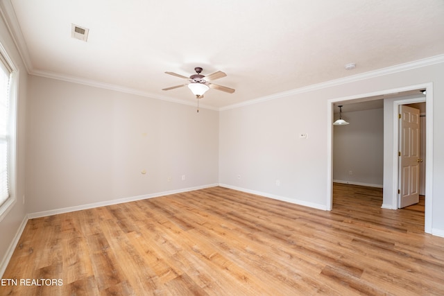 spare room with crown molding, ceiling fan, and light wood-type flooring