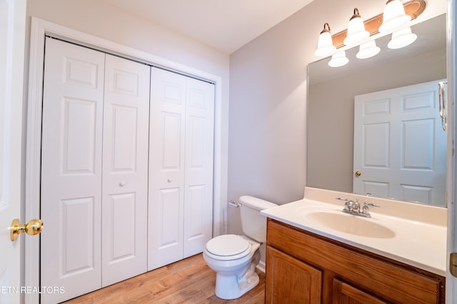 bathroom with vanity, hardwood / wood-style flooring, and toilet