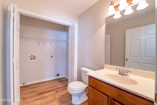 bathroom with vanity, wood-type flooring, and toilet