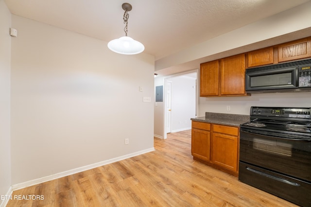 kitchen featuring decorative light fixtures, electric panel, light hardwood / wood-style flooring, and black appliances