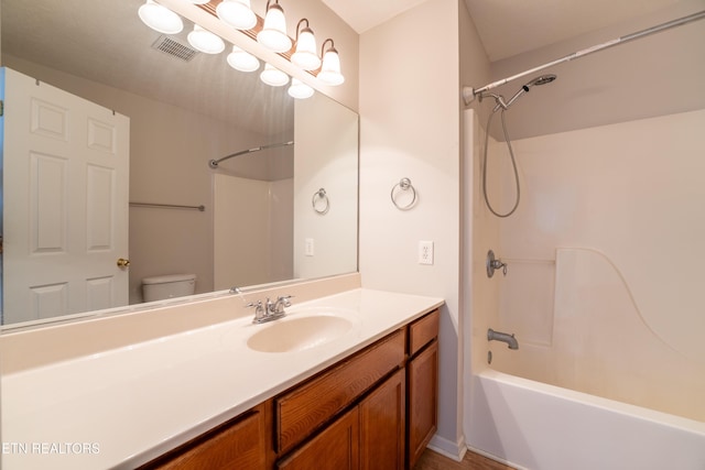 full bathroom with vanity, bathing tub / shower combination, and toilet