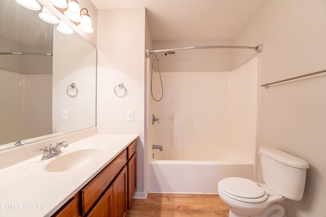 full bathroom with shower / bath combination, vanity, wood-type flooring, toilet, and a chandelier