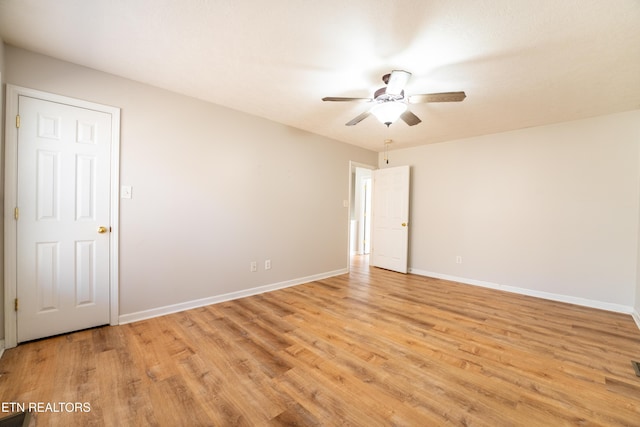 spare room featuring ceiling fan and light hardwood / wood-style flooring