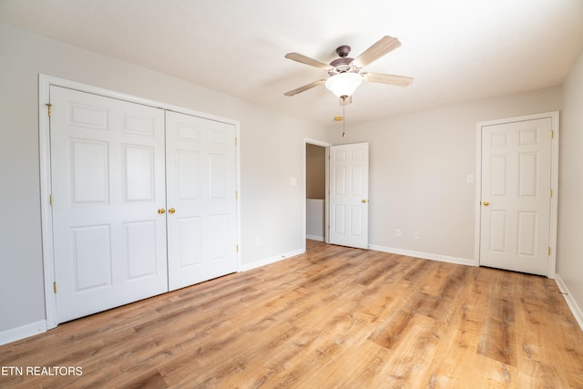 unfurnished bedroom featuring ceiling fan, light hardwood / wood-style floors, and a closet