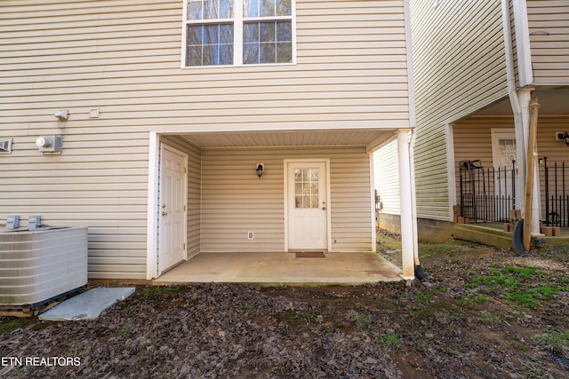 entrance to property featuring a patio and central air condition unit