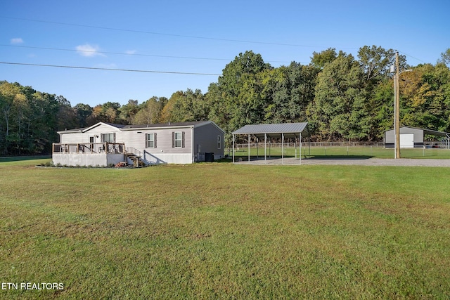 view of front of property featuring a carport, a wooden deck, and a front lawn