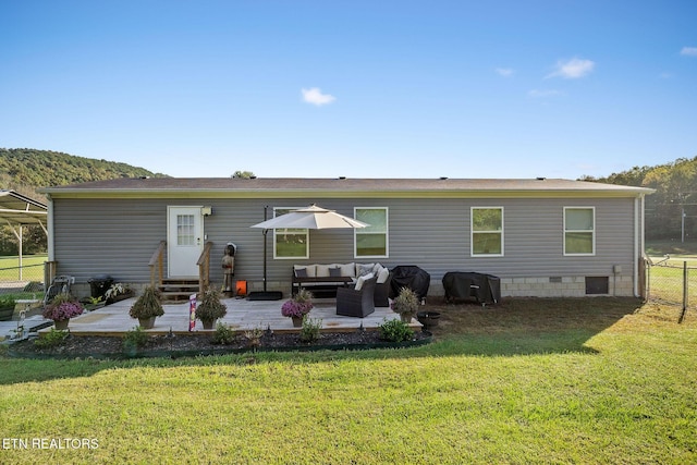 back of property with an outdoor hangout area, a lawn, and a patio