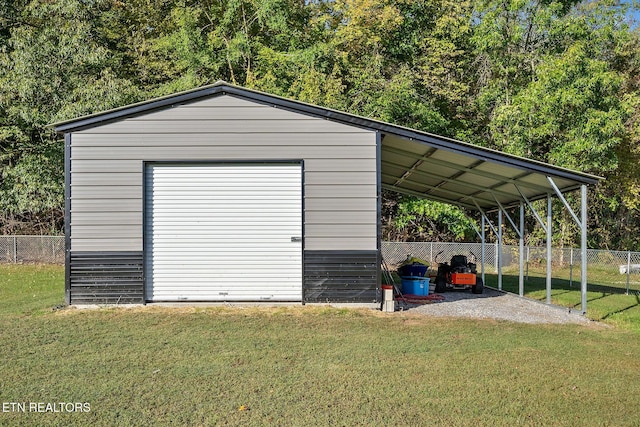 view of outbuilding featuring a garage, a yard, and a carport