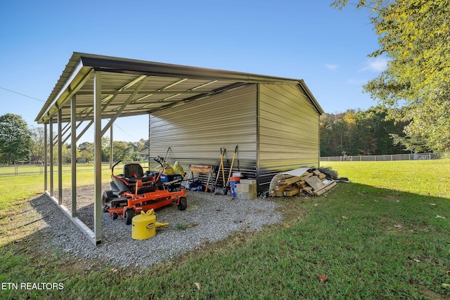 view of outdoor structure with a carport and a yard