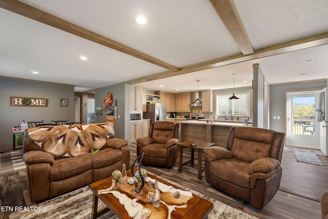 living room with beamed ceiling, crown molding, and dark hardwood / wood-style floors