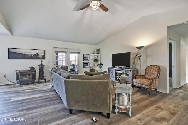 living room featuring hardwood / wood-style flooring, vaulted ceiling, and ceiling fan