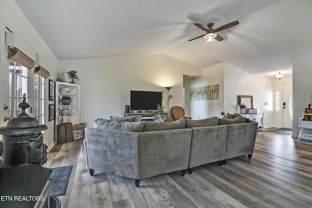 living room with ceiling fan, lofted ceiling, hardwood / wood-style floors, and plenty of natural light