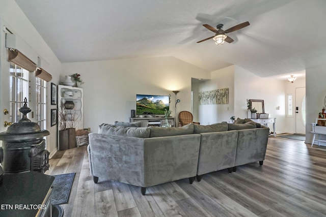 living room featuring lofted ceiling, hardwood / wood-style floors, and ceiling fan