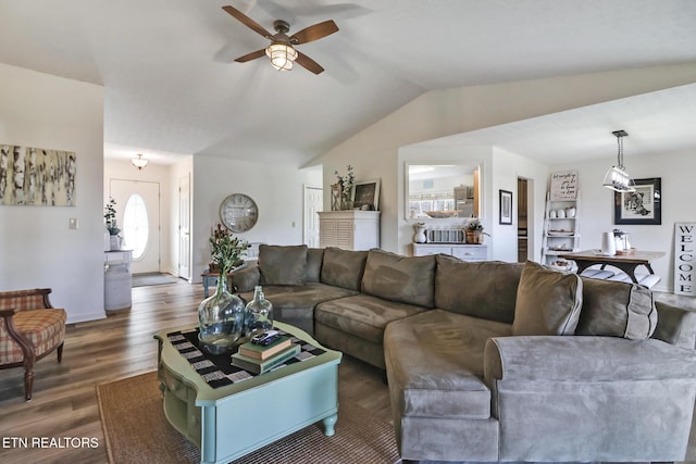 living room with dark wood-type flooring, ceiling fan, and vaulted ceiling