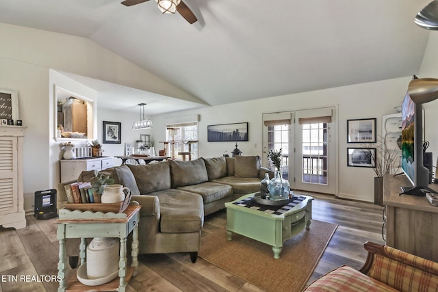 living room featuring ceiling fan, lofted ceiling, dark hardwood / wood-style floors, and a wealth of natural light