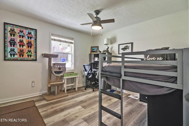 bedroom featuring hardwood / wood-style floors and a textured ceiling