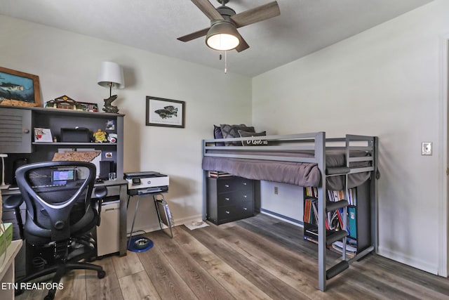 bedroom with dark wood-type flooring and ceiling fan