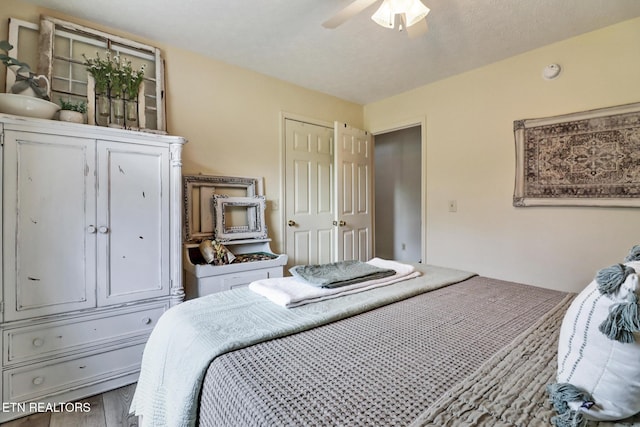 bedroom featuring hardwood / wood-style flooring and ceiling fan