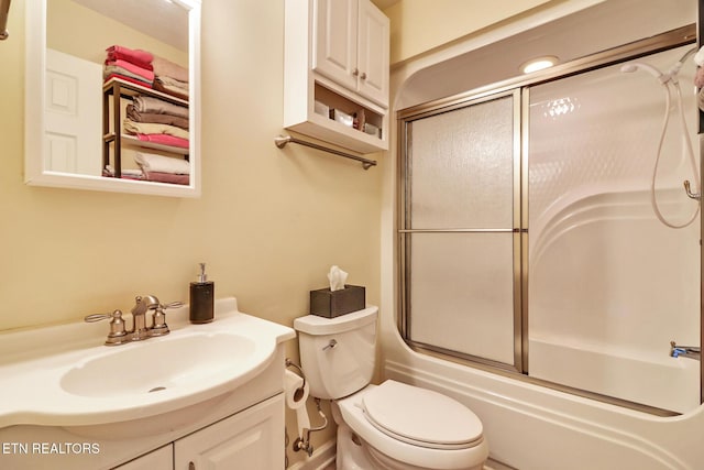 full bathroom with vanity, shower / bath combination with glass door, and toilet