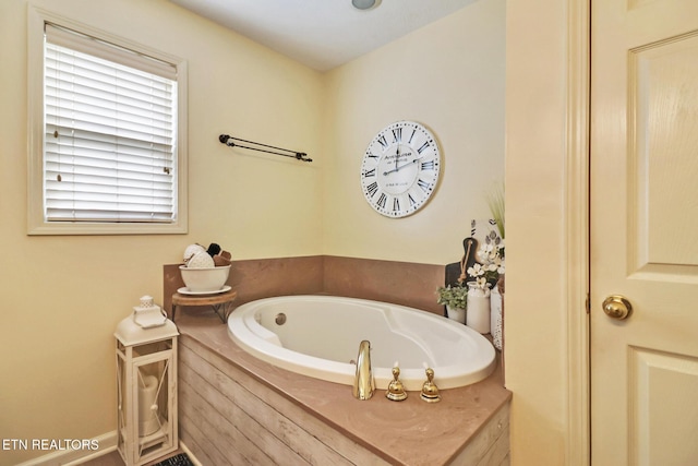 bathroom with tiled tub