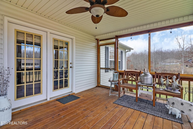 sunroom / solarium featuring ceiling fan