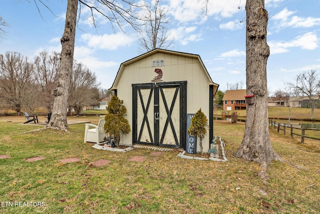 view of outbuilding featuring a lawn