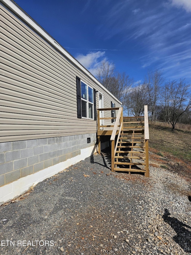 view of side of property featuring a wooden deck