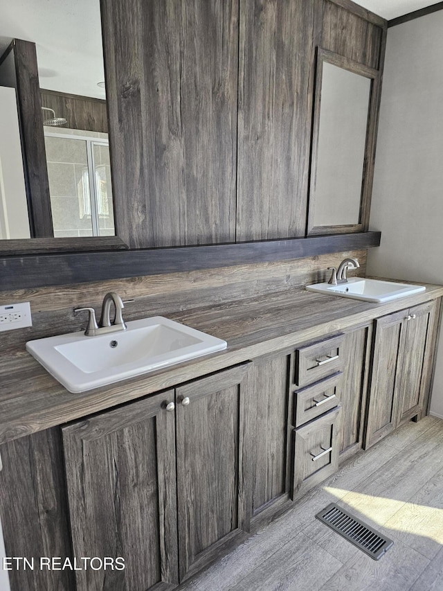 bathroom featuring vanity and hardwood / wood-style floors