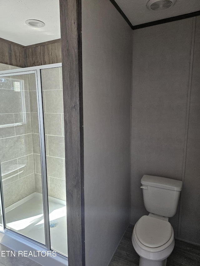 bathroom with walk in shower and toilet