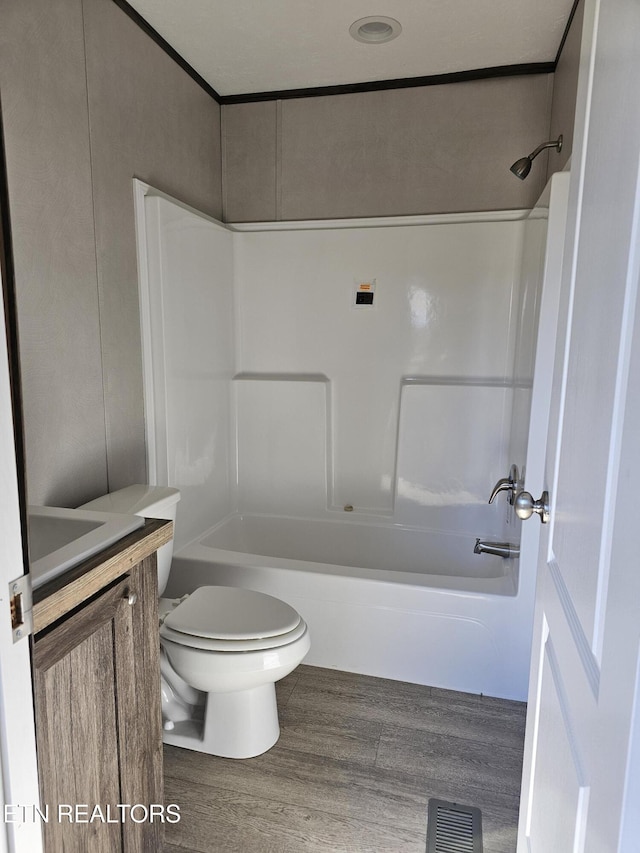 full bathroom with vanity, wood-type flooring, shower / tub combination, and toilet