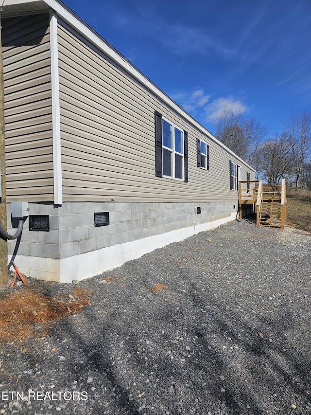 view of side of home with a deck