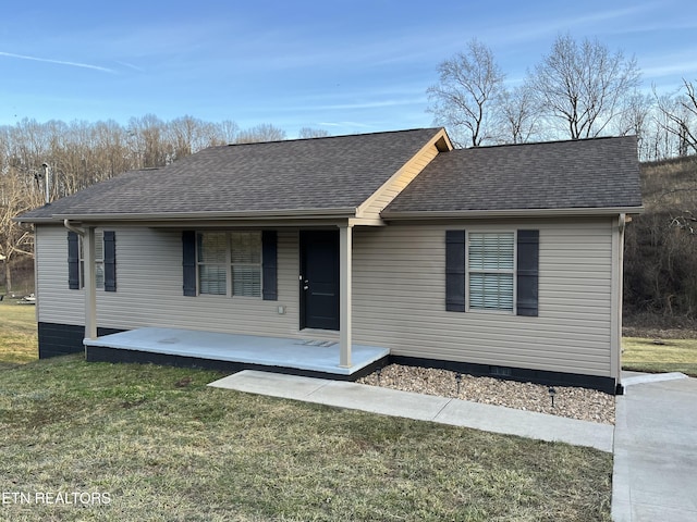 view of front of house with a patio area and a front lawn