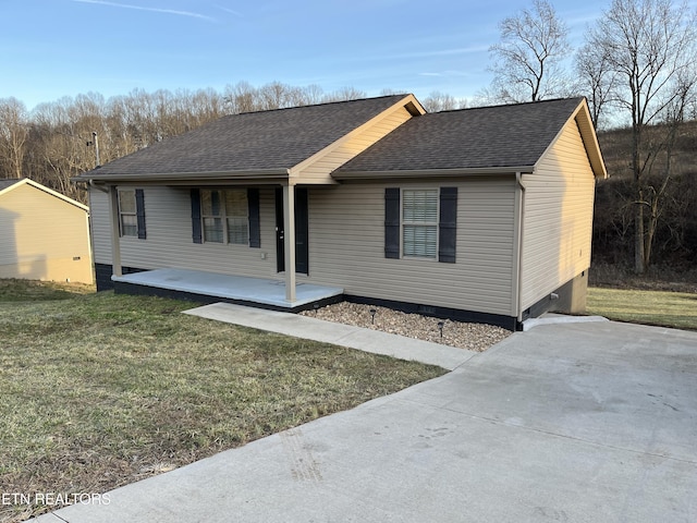 single story home with a front yard and a patio area