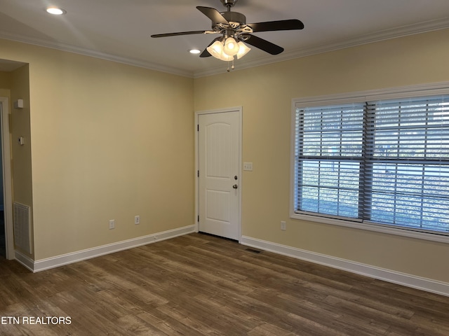 spare room with ornamental molding, dark hardwood / wood-style floors, and ceiling fan