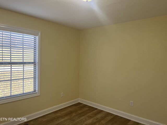 empty room featuring dark wood-type flooring