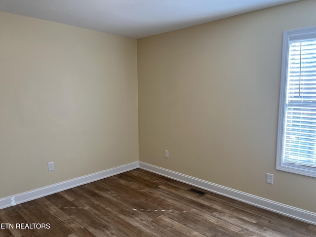 unfurnished room with dark hardwood / wood-style floors