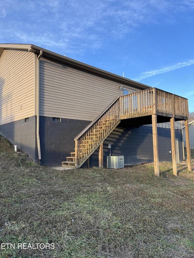 view of side of home with cooling unit and a deck