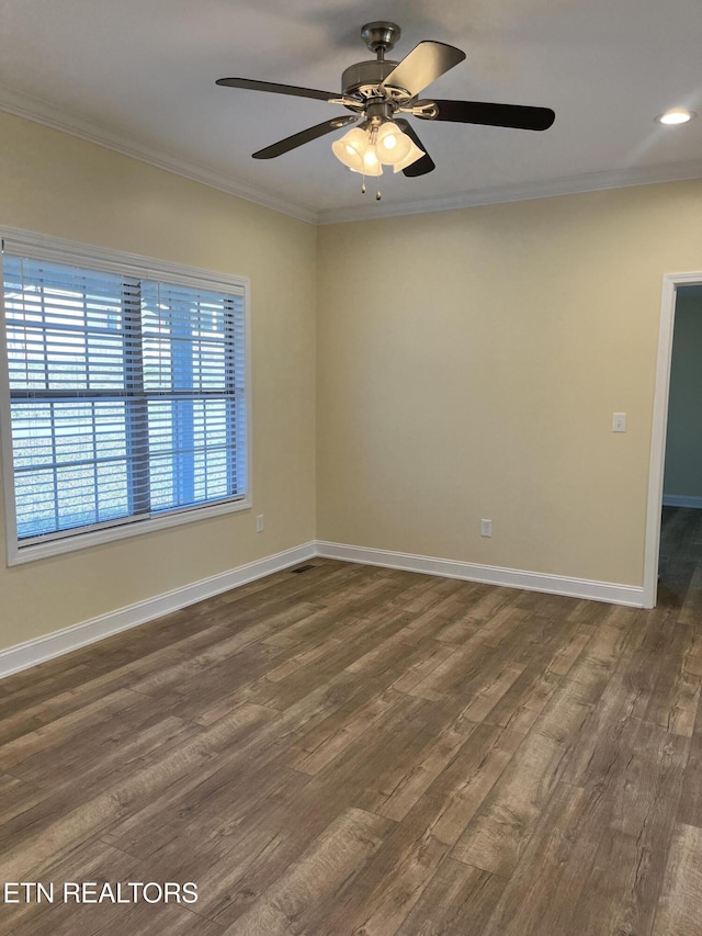 spare room featuring crown molding and dark wood-type flooring