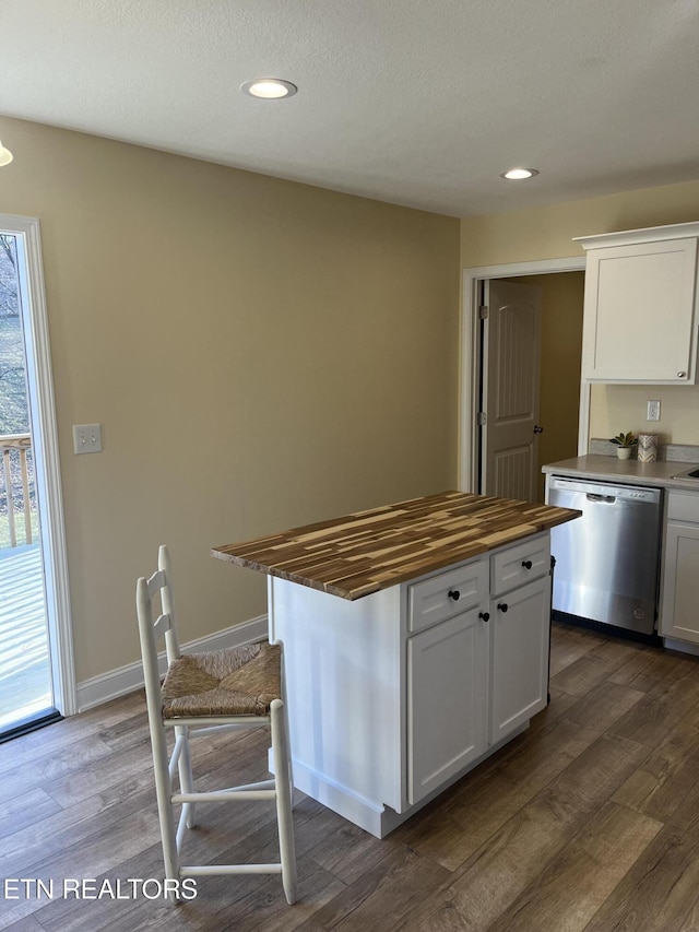 kitchen featuring wood counters, a center island, dark hardwood / wood-style flooring, dishwasher, and white cabinets