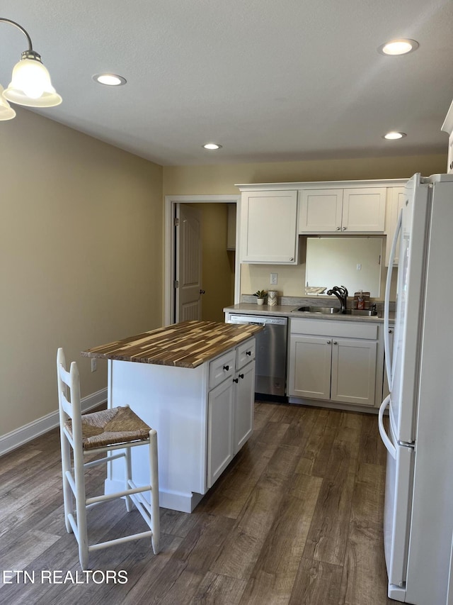 kitchen featuring sink, dishwasher, white cabinetry, a center island, and white refrigerator