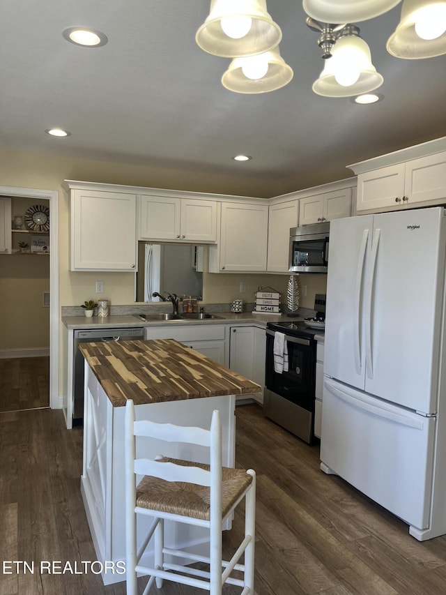 kitchen with white cabinetry, appliances with stainless steel finishes, sink, and wooden counters