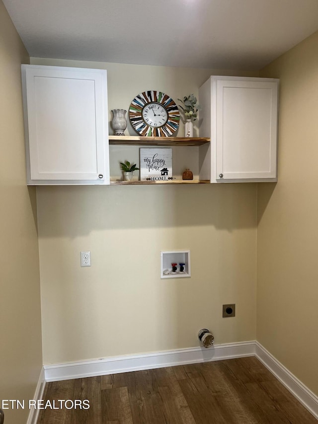 clothes washing area featuring electric dryer hookup, washer hookup, dark hardwood / wood-style flooring, and cabinets