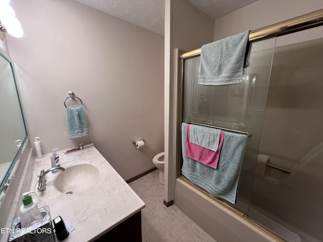 full bathroom with enclosed tub / shower combo, vanity, toilet, tile patterned floors, and a textured ceiling