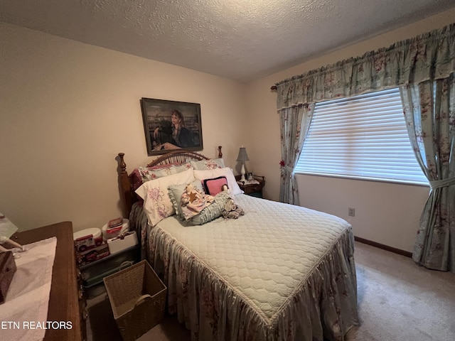 bedroom with a textured ceiling and carpet flooring