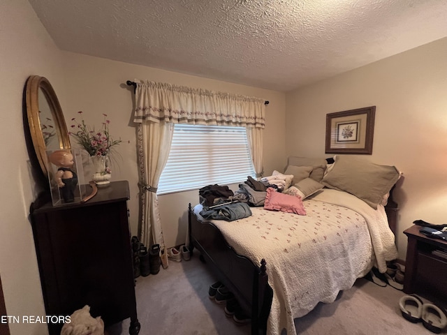 bedroom with carpet flooring and a textured ceiling