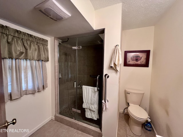 bathroom featuring tile patterned flooring, walk in shower, a textured ceiling, and toilet