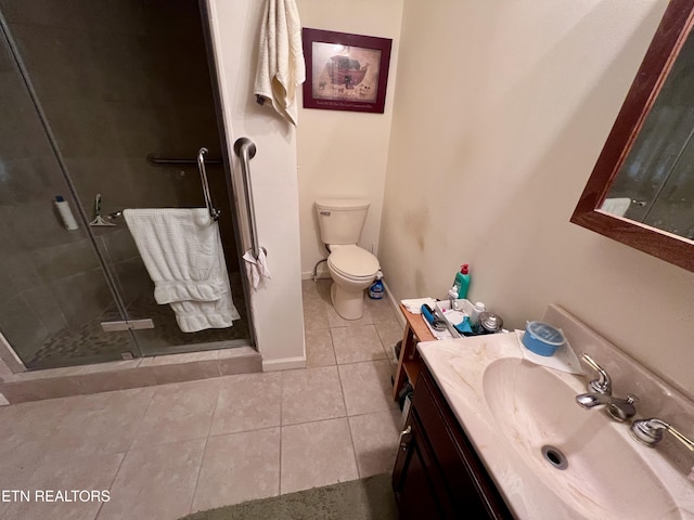 bathroom featuring vanity, a shower with shower door, tile patterned floors, and toilet